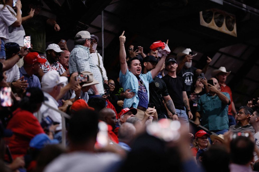 MAGA fan assaults Trump protester on his way out the door at Texas rally