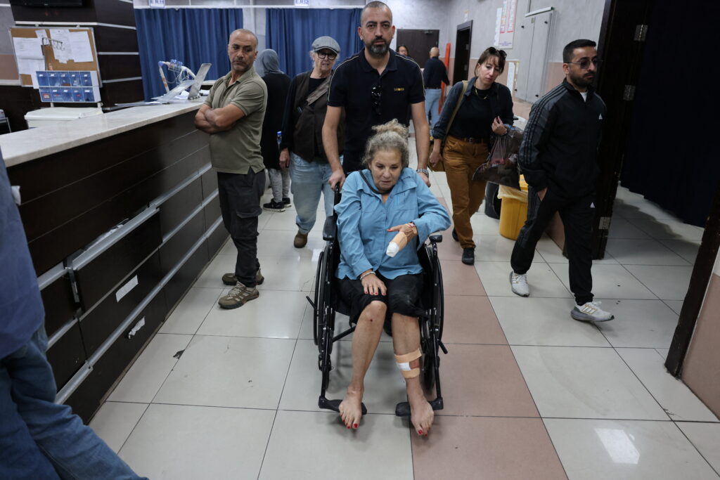 Israeli settlers beat Palestinians and a U.S. photojournalist in West Bank attacks